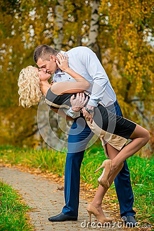 Young couple passionately kissing in park Stock Photo