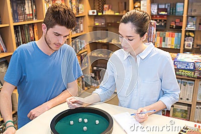 Young couple playing dice game Stock Photo