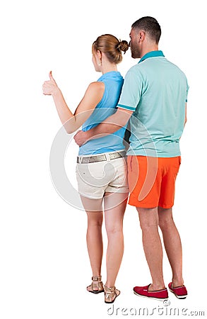 Young couple pointing at wal Back view Stock Photo