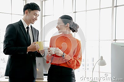 Young couple of professionals chatting during coffee break Stock Photo