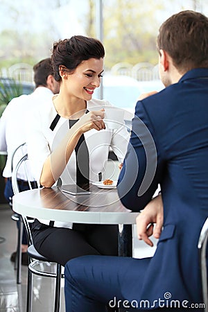 Young couple of professionals chatting during a coffeebreak Stock Photo