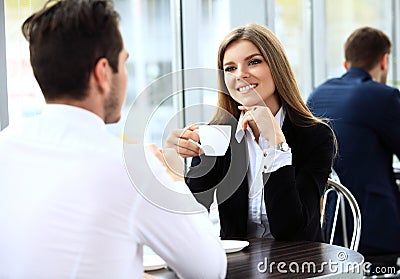 Young couple of professionals chatting during a coffeebreak Stock Photo