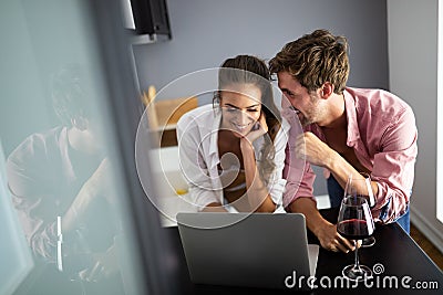Young couple relaxing at home with laptop. Love,happiness,people and fun concept. Stock Photo