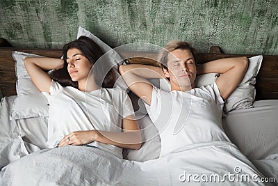 Young couple resting sleeping well together in comfortable bed Stock Photo