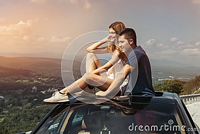 Young couple on road trip travel by car together and enjoy the nature view from the top Stock Photo