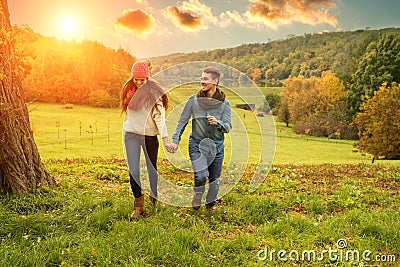 Young couple running on the beautiful scenery Stock Photo