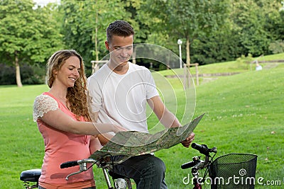 Young couple searching the direction during a bicycle tour Stock Photo