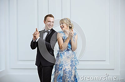 Young couple showing gun gesture and wearing luxury fashionable Stock Photo