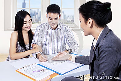 Young couple signing financial contract Stock Photo