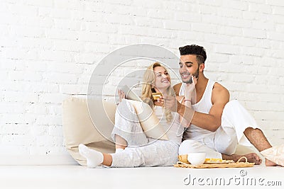 Young Couple Sit Floor, Hispanic Man Woman Using Tablet Computer Credit Card Online Payment Lovers Bedroom Stock Photo