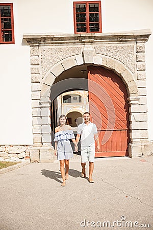 Young couple siteseeing on a hot summer afternoon on a paved street Stock Photo