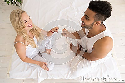 https://thumbs.dreamstime.com/x/young-couple-sitting-bed-smiling-woman-give-man-condom-lovers-contraception-protection-bedroom-top-angle-view-79942809.jpg