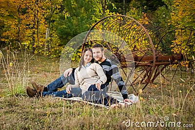 Young couple sitting on blanket outside Stock Photo