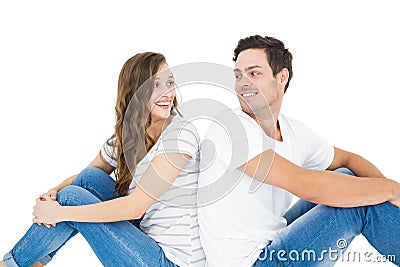 Young couple sitting on floor back to back Stock Photo