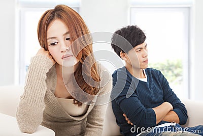 Young Couple sitting on the sofa during conflict Stock Photo