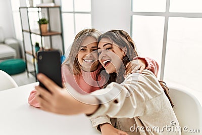 Young couple smiling happy making selfie by the smartphone at home Stock Photo