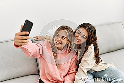 Young couple smiling happy making selfie by the smartphone at home Stock Photo