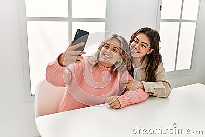 Young couple smiling happy making selfie by the smartphone at home Stock Photo