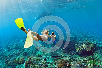 Young couple in snorkeling mask free dive underwater in sea Stock Photo