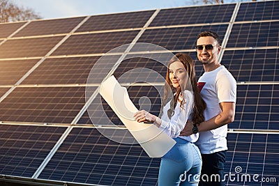 Young couple by a solar module Stock Photo