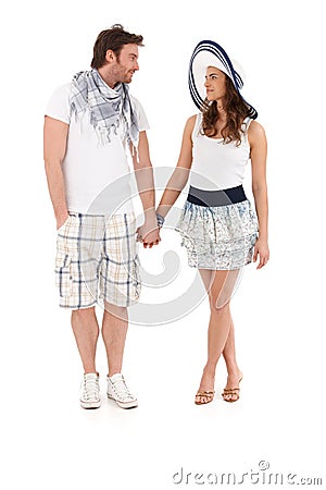 Young couple in summer outfit walking hand in hand Stock Photo