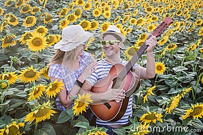 Young couple in sunflower field Stock Photo