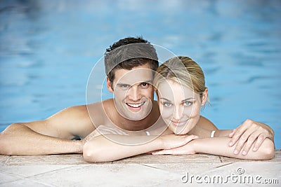 Young Couple Swimming In Pool Stock Photo