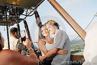 A young couple taken pictures in a hot air balloon Editorial Stock Photo