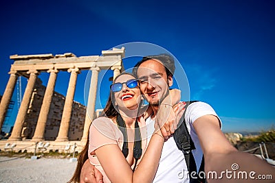 Young couple taking selfie picture with Erechtheum temple on background in Acropolis Stock Photo