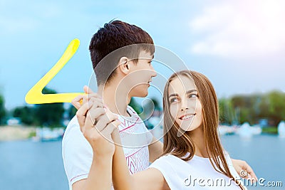 Young couple throwing boomerang. Summer outdoor activities Stock Photo