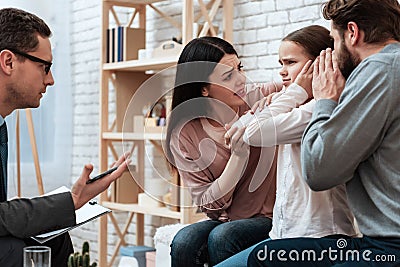 Young couple tries to reach out to small daughter. Stock Photo