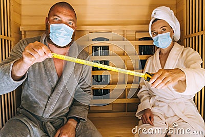 Young couple trying to relax in SPA during corona virus pandemic Stock Photo