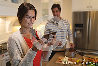 Young couple using tablet computer while cooking Stock Photo