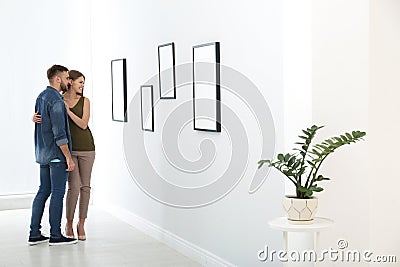 Young couple viewing exposition in art gallery Stock Photo