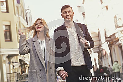 Young couple walk at the street on sunny day Stock Photo