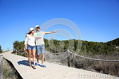 Young couple walking on a wooden pontoon Stock Photo