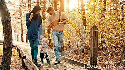 A young couple walks in the woods with a little boy Stock Photo