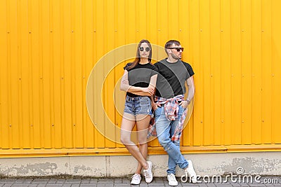 Young couple wearing black t-shirts near color wall Stock Photo