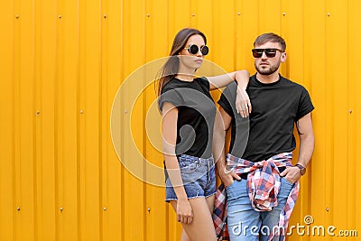 Young couple wearing black t-shirts near color wall Stock Photo