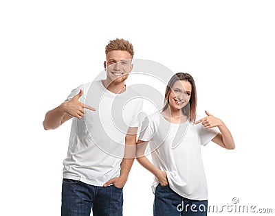 Young couple wearing blank t-shirts on white. Mockup for design Stock Photo