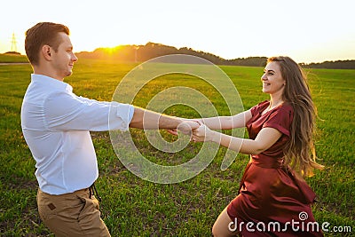 Young couple whirls in field Stock Photo