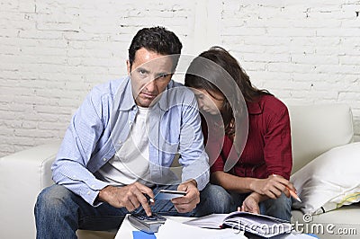 Young couple worried and desperate on money problems at home in stress accounting bank payments Stock Photo