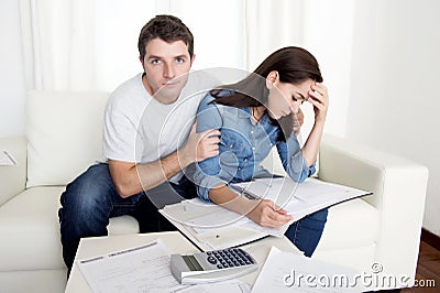 Young couple worried home in stress husband comforting wife in financial problems Stock Photo