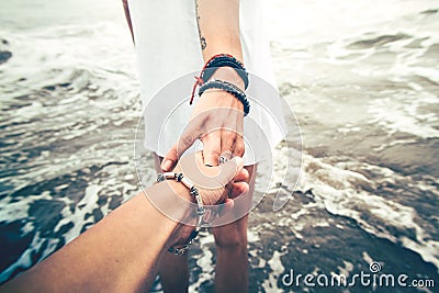 Holding hands on the beach Stock Photo