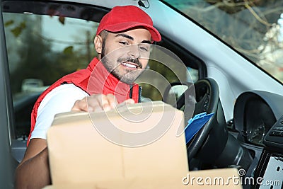 Young courier checking amount of parcels Stock Photo