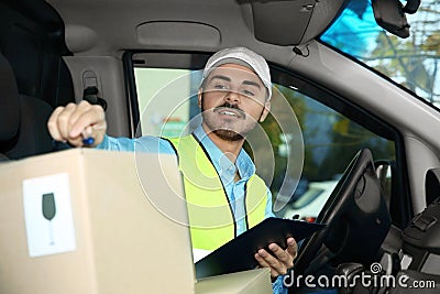 Young courier checking amount of parcels Stock Photo