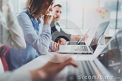 Young Coworkers working with mobile computers at sunny meeting room.Horizontal. Stock Photo