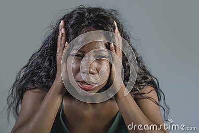 Young crazy desperate and anxious black african American woman feeling stressed and tormented in intense and dramatic face express Stock Photo