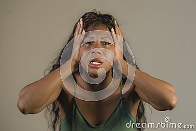 Young crazy desperate and anxious black african American woman feeling stressed and tormented in intense and dramatic face express Stock Photo