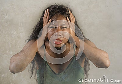 Young crazy desperate and anxious black african American woman feeling stressed and unwell in intense and dramatic face expression Stock Photo